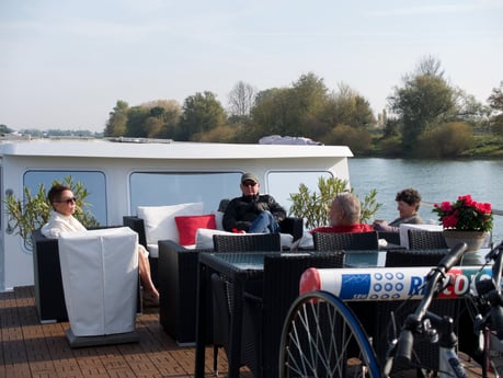 Guests relax on the Grand Victoria front deck while cruising the the River Saône